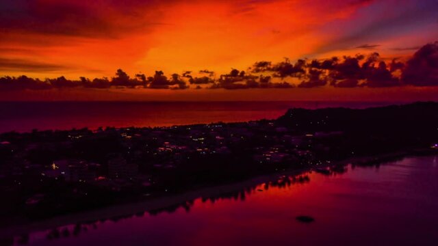 A drone time lapse showing a beautiful sunset over the ocean with Boracay island in the foreground 