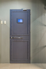 Image of locked metal grey door with window of lab in lost room.