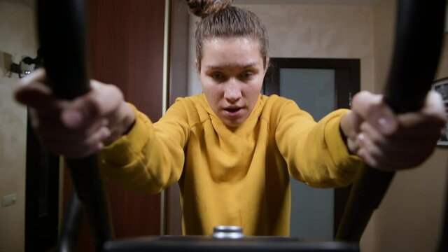 Hard training girl in sweat, wide angle. Home fitness