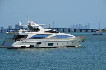 White motor yacht slowly cruising on the Florida Intra-Coastal Waterway off Miami Beach.