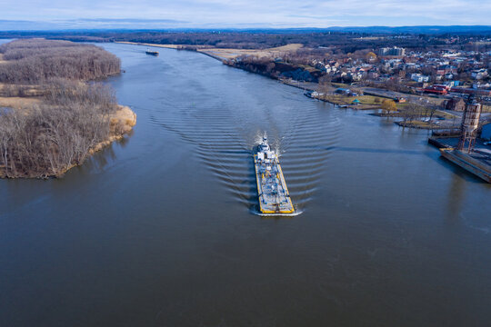 Tug and oil barge headed south towards aerial camera on the hudson river passing hudson ny