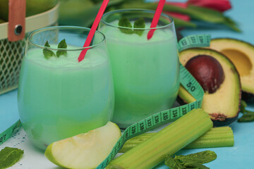 
two glasses of vegetable smoothie.