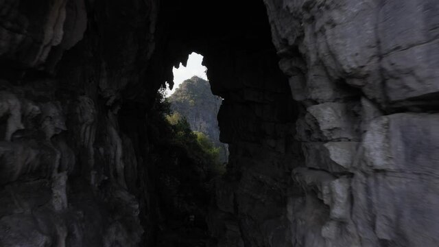 Amazing stone natural archway in karst mountain, aerial pull-back reveal