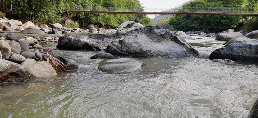 Rocks in the river in West Java. Large stones in the water.