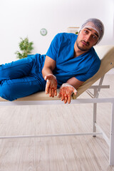 Young male doctor surgeon in fatal negligence concept