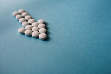 Tablets shaping an arrow on blue background.