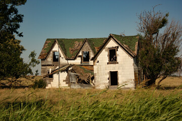 Dilapidated Abandoned Farm House in an Open Field in USA