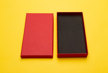 Fototapeta premium Red box product packaging isolated on yellow background.