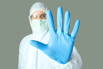 Doctor wore a protective gown from the coronavirus and he raised his hand to stop.Medical concepts