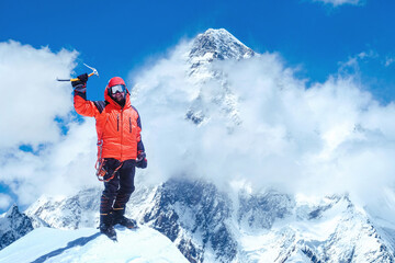 Fototapeta na wymiar Climber reaches the summit of mountain peak, Nepal.