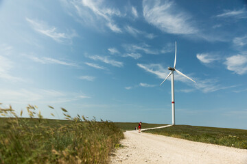 Fototapeta na wymiar Windmills for electric power - Energy Production with clean and Renewable Energy