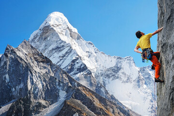 Climber reaches the summit of mountain peak. Success freedom and happiness achievement in...