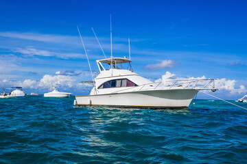 Yacht boat sailing in blue Carribean sea and Atlantic ocean. Tropical landscape with blue water and sky of the Dominican republic island