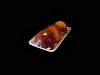 red peach isolated on black background