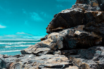 Fototapeta na wymiar Rock formation on beach in california
