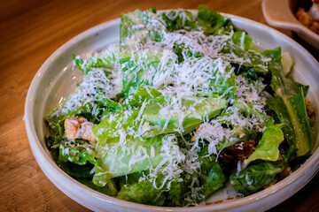 A fresh caesar salad on a wooden table