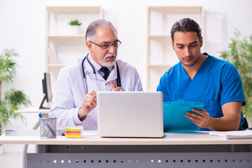 Two male doctors working in the clinic