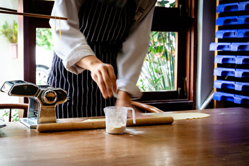 Woman chef doing pasta from pasta dough