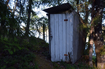 Wooden toilet hut in the forest. Norway