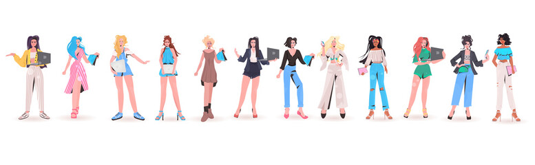 Fototapeta premium set mix race women using digital devices beautiful girls in trendy clothes female cartoon characters collection full length isolated horizontal vector illustration