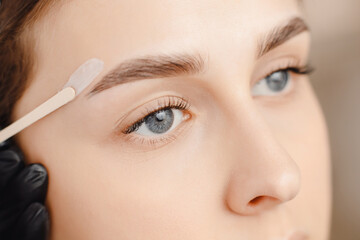 Master wax depilation of eyebrow hair in women, brow correction