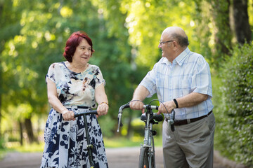 Happy elderly couple. Handsome man and woman senior citizens. Husband and wife of old age in the park.