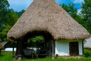 Plakat traditional clay and brick house with straw and wood roof
