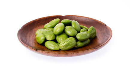 Parkia speciosa seeds or bitter bean on dish isolated on white background