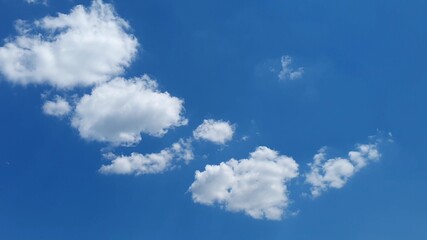 white clouds disappear in the hot sun on blue sky. Time-lapse motion clouds, blue sky background and sun