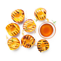 Summer dessert. Ripe grilled peaches with honey isolated on white background