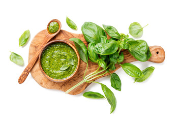 Traditional italian sauce pesto with green basil in wooden bowl isolated on white background
