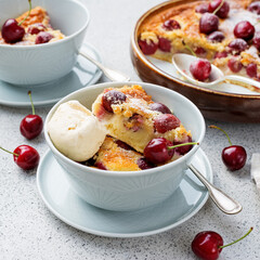 Traditional french pie clafoutis with cherry served with ice cream.