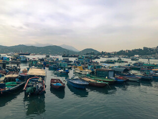 Fototapeta premium Boats stopped by the pier in the evening at Cheung Chau Island, Hong Kong.