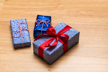 gift box with red ribbon on wooden background