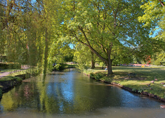Fototapeta na wymiar The River Lea flows through the grounds of Hertford Castle, Hertfordshire, England, UK.