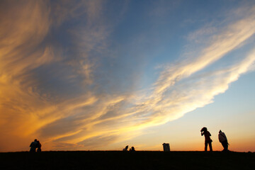Fototapeta na wymiar Silhouettes of people against the sunset