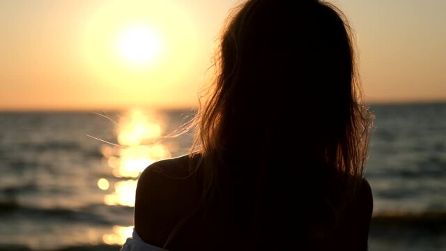 Portrait of a free girl with long hair in the sunset light.