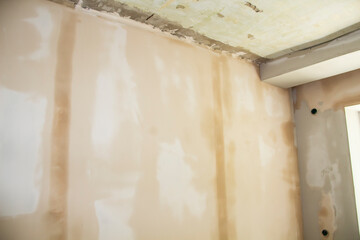 Fototapeta na wymiar Repair work in the apartment. Concept of home improvement or renovate. Primed painting walls