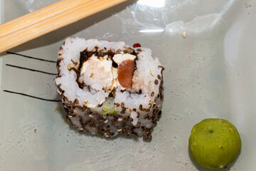 Japanese sushi food is excellent. Maki and rolls with tuna, salmon and avocado. Top view of sushi roll. wasabi.Selective focus.