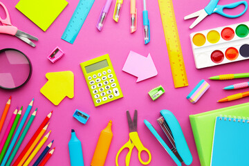 School supplies on pink background with copy space. Back to school. Flat lay.