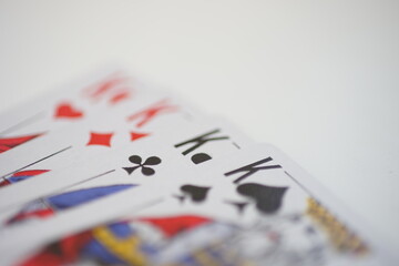 Side view of kings cards on a white table.