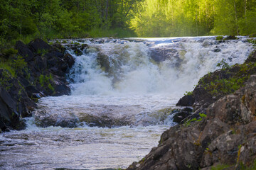 The upper threshold of the Kivach waterfall close up on a June sunny evening. Karelia, Russia