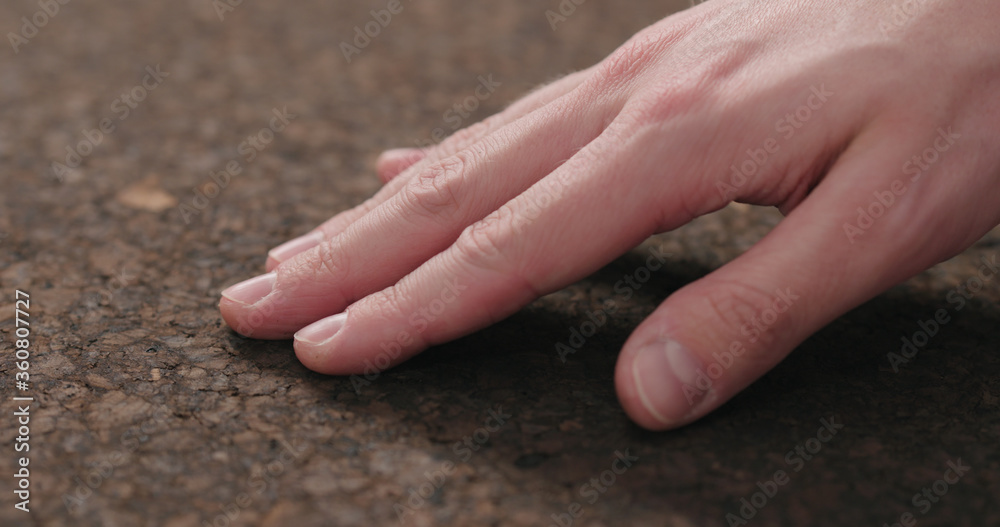 Poster man hand touch dark cork surface with oil finish