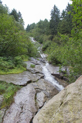 Fototapeta na wymiar Mountain waterfall in forest, Braone, Lombardy, Italy.
