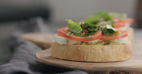 bruschetta with tomato, pesto and mozzarella on olive board