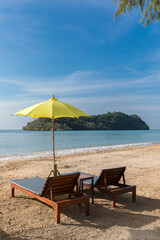 Fototapeta na wymiar yellow beach umbrella and sunbed, Koh Mak beach, Koh Mak Island , Thailand.