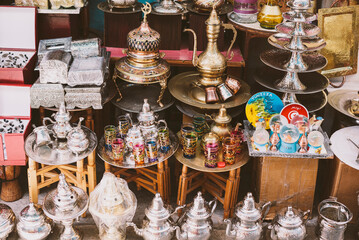 Fototapeta na wymiar Tunisia, Tunisia - June 1, 2020. The eastern market in the medina of Tunisia with beautiful colored dishes, teapots and souvenirs.
