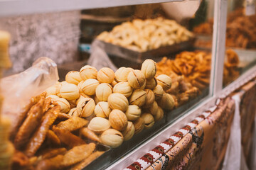 Showcase on the market with oriental sweets: baklava, cookies, nuts. Mouth-watering desserts
