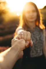 Couple is getting engaged, man propose woman. Engagement ring and family celebration.