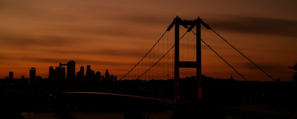 Istanbul Strait, sunset red sky over bridge.
